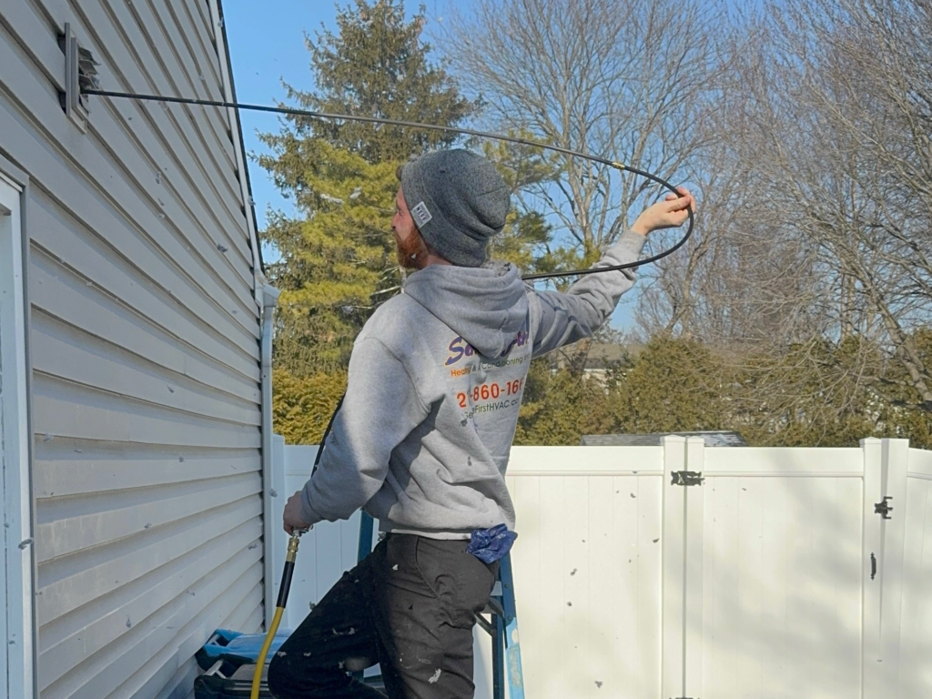 HVAC technician performing professional air duct camera inspection on home ductwork