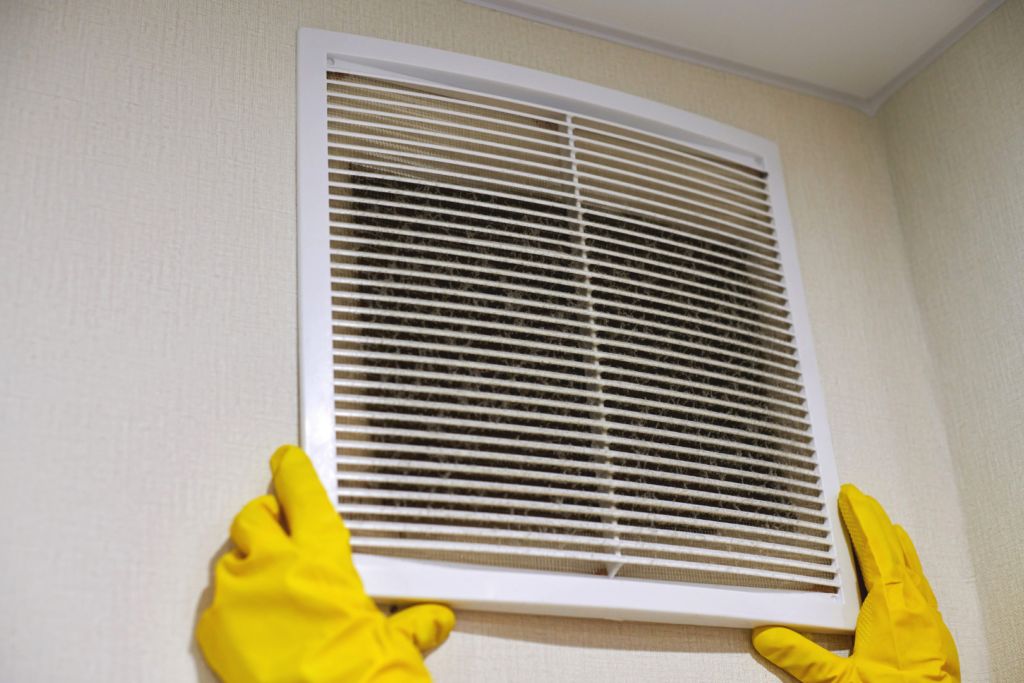Dust buildup around air vent showing signs of dirty ductwork in home